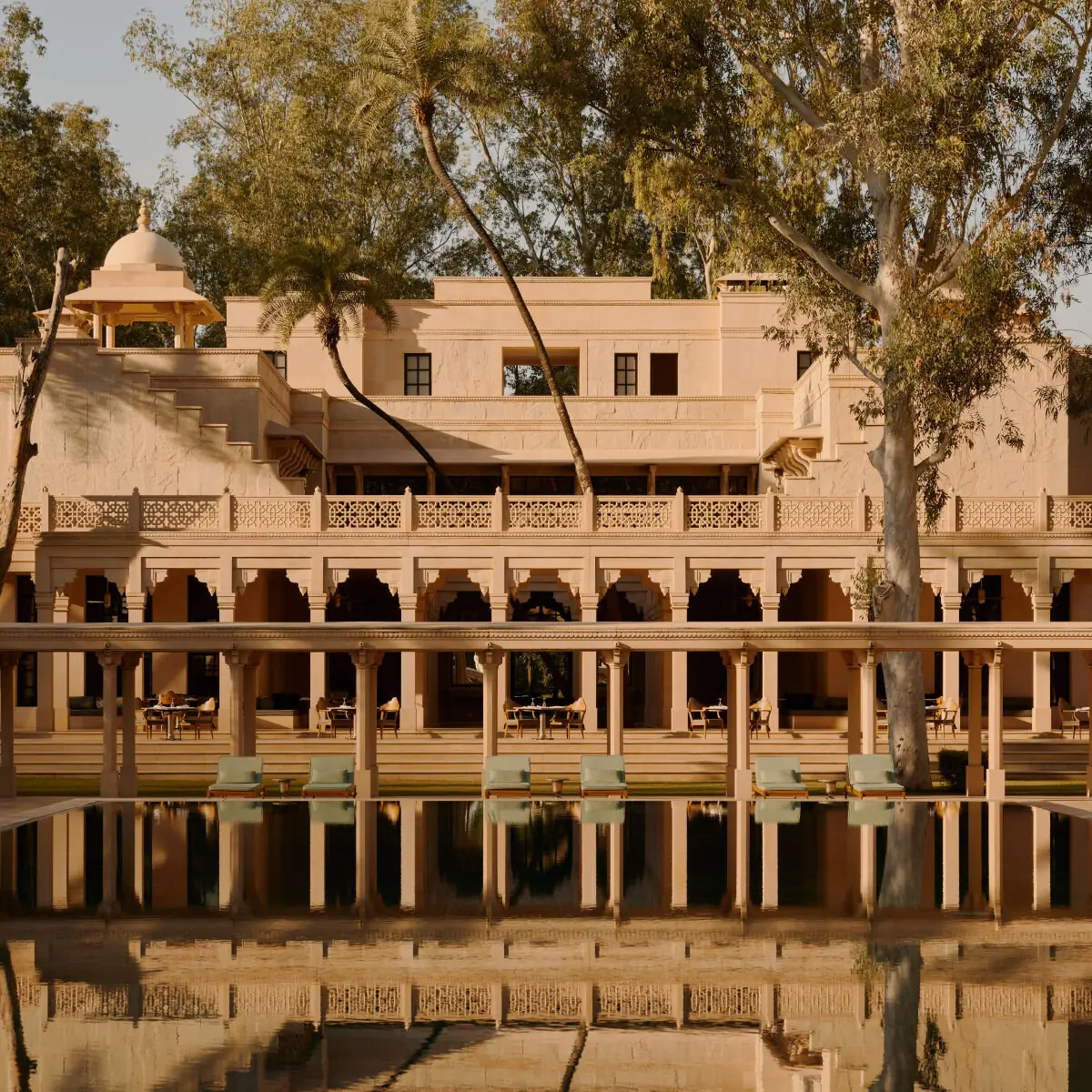 Sandstone façade and colonnade reflected in the pool at Amanbagh, Ajabgarh.