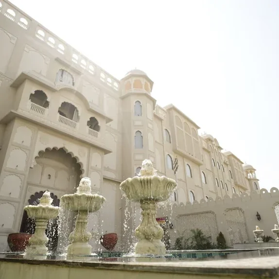 White palace-style façade and ornamental fountains at Anant Mahal.