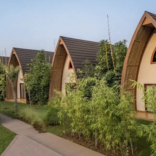 Pitched-roof resort cottages beside landscaped paths at Ananta Ajabgarh.