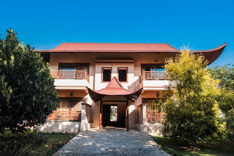 Daylight photograph of the entrance and red tiled roof at Ananta Spa & Resort Jaipur.