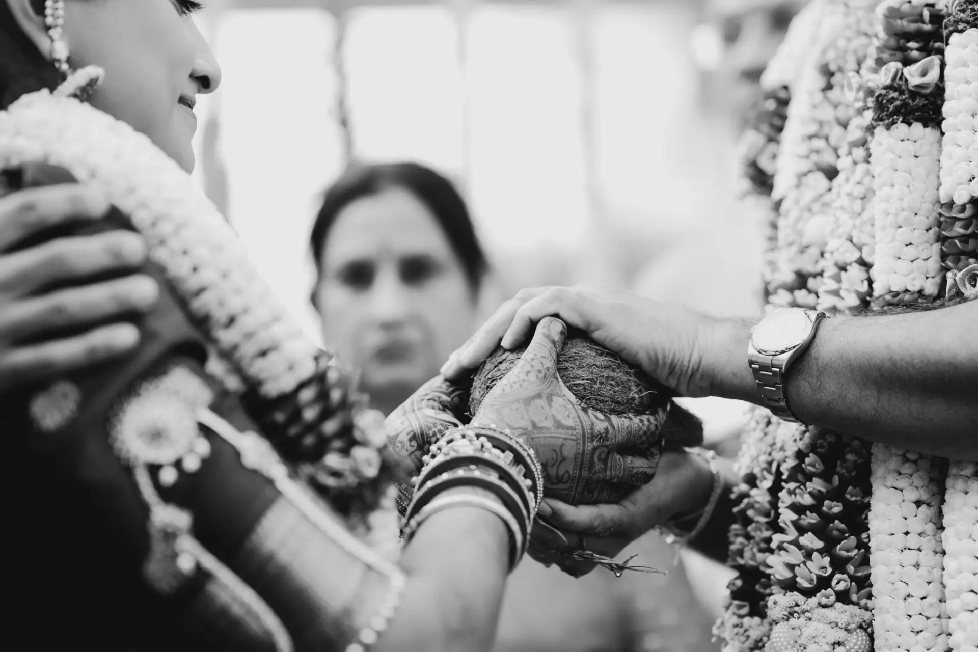 Black and white photograph of hands during the wedding ritual at Hyatt Regency Jaipur Mansarovar, Jaipur