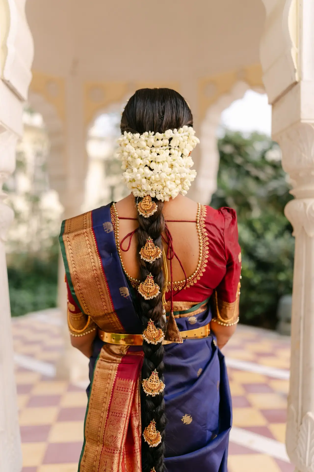 Ankita’s braided bridal hairstyle with flowers and silk saree at Hyatt Regency Jaipur Mansarovar, Jaipur