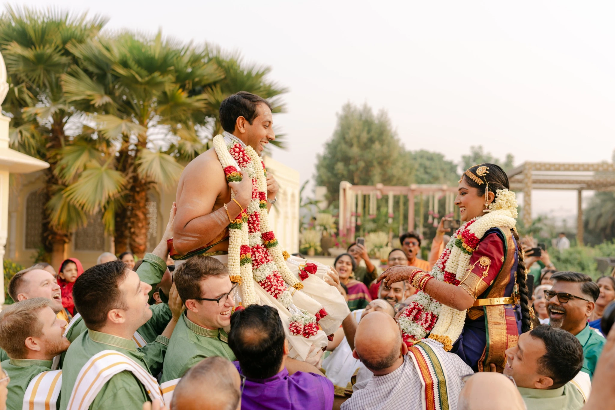 Couple lifted by family during the garland exchange at Hyatt Regency Jaipur Mansarovar, Jaipur