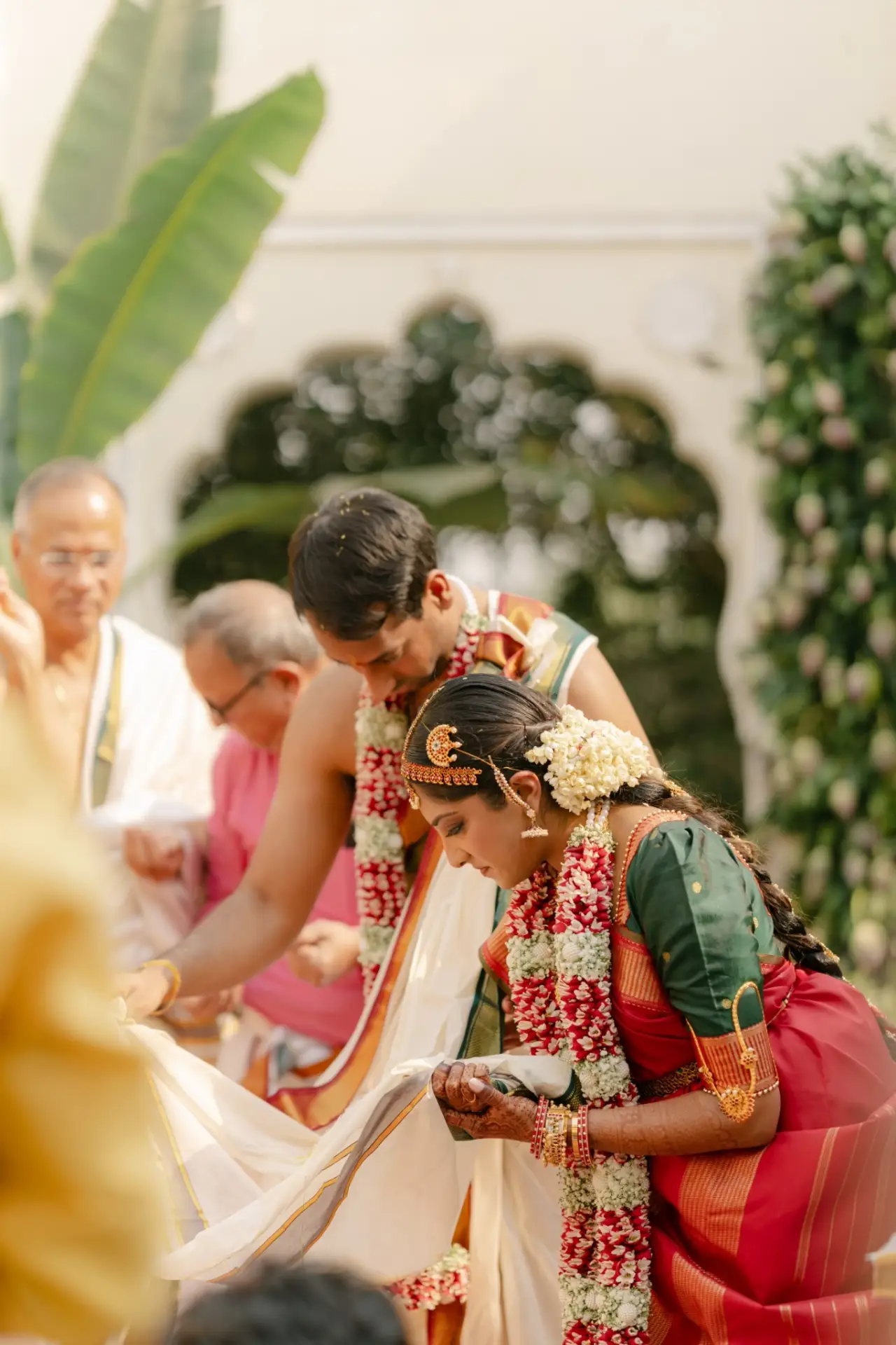 Ankita and Ajay sharing a wedding ritual beneath the floral canopy at Hyatt Regency Jaipur Mansarovar, Jaipur