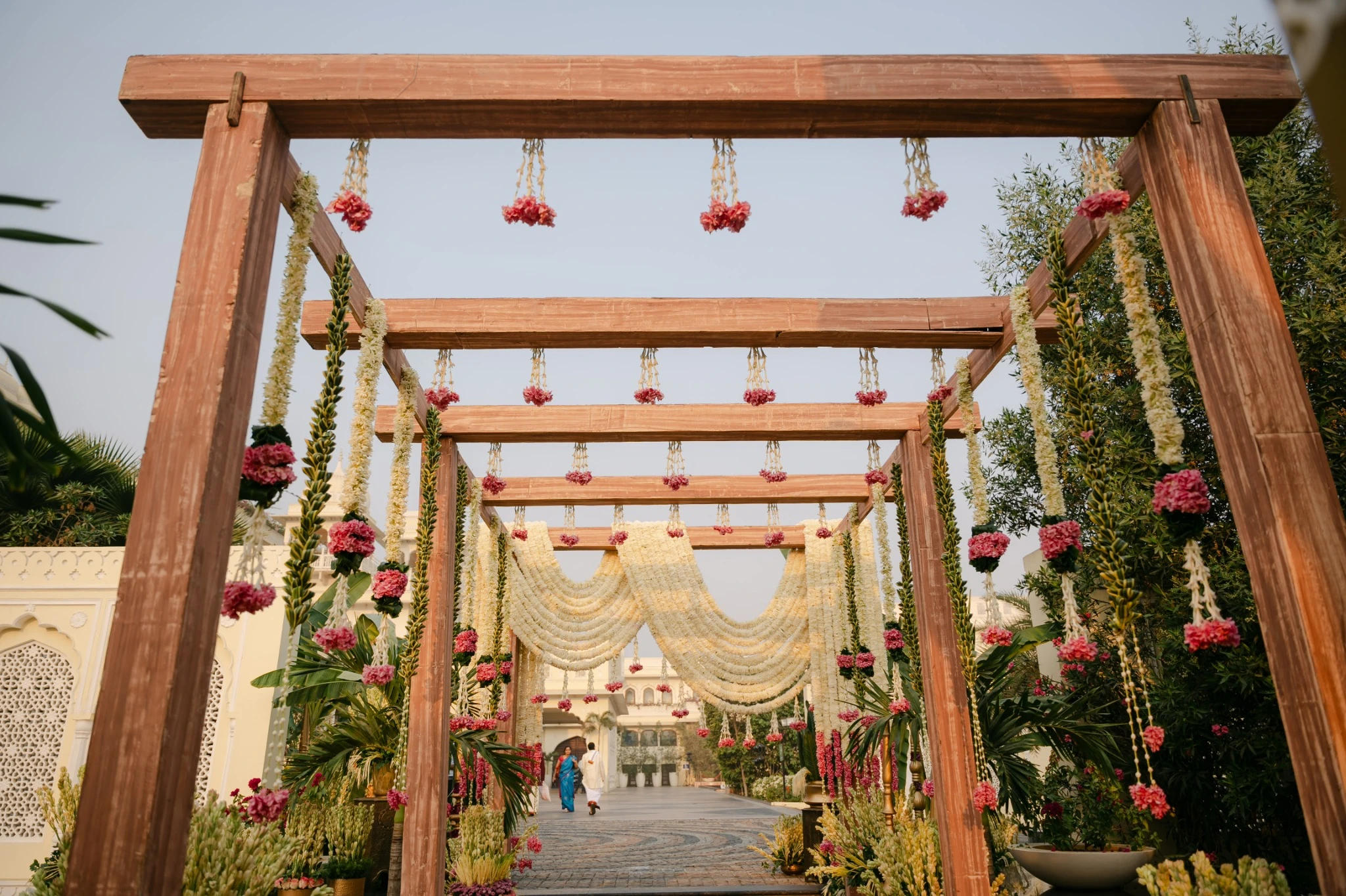 Wooden entrance passage with floral hangings at Hyatt Regency Jaipur Mansarovar, Jaipur