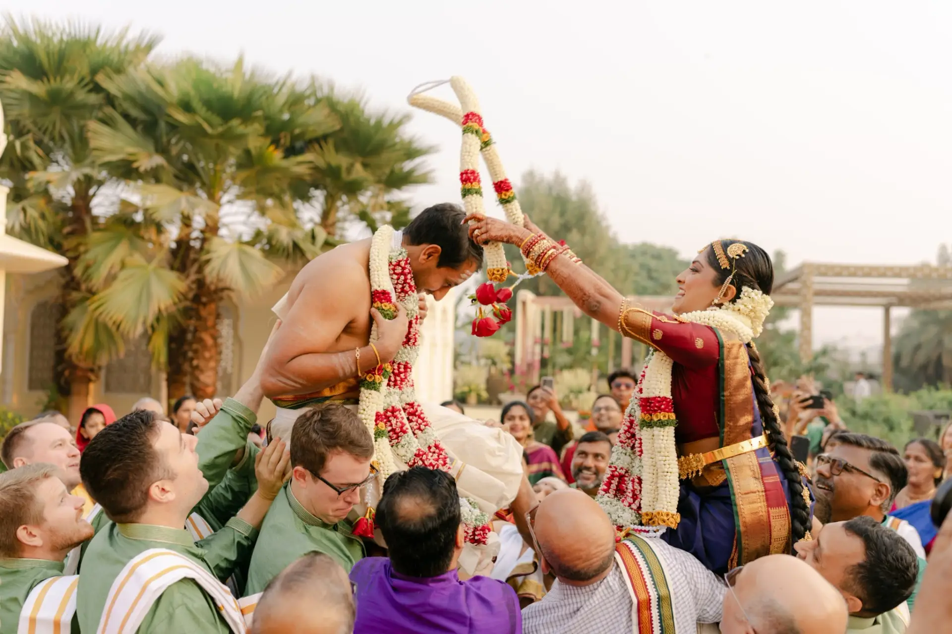 Ankita and Ajay exchanging flower garlands surrounded by family at Hyatt Regency Jaipur Mansarovar, Jaipur