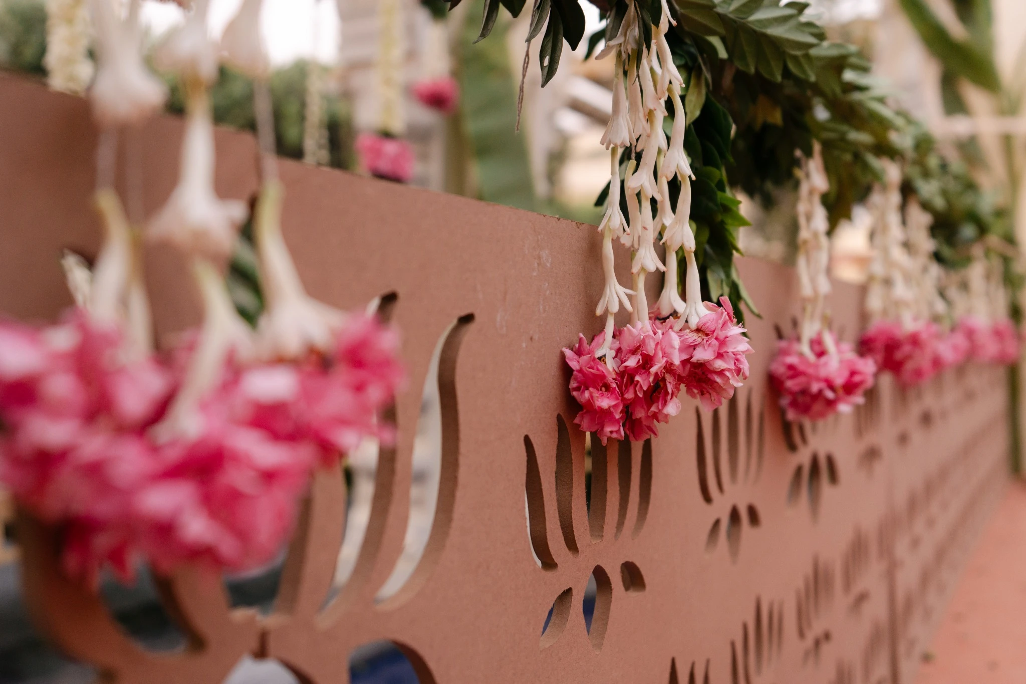 Pink and white floral hangings against kolam-patterned fabric at Hyatt Regency Jaipur Mansarovar, Jaipur