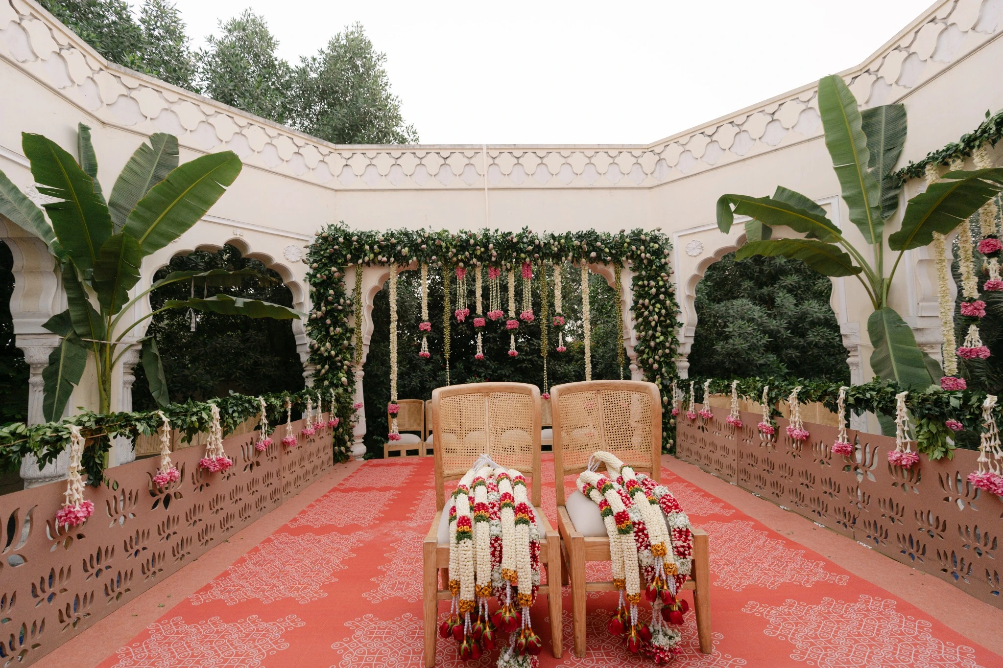 Kolam-inspired ceremonial floor and wooden mandap chairs at Hyatt Regency Jaipur Mansarovar, Jaipur