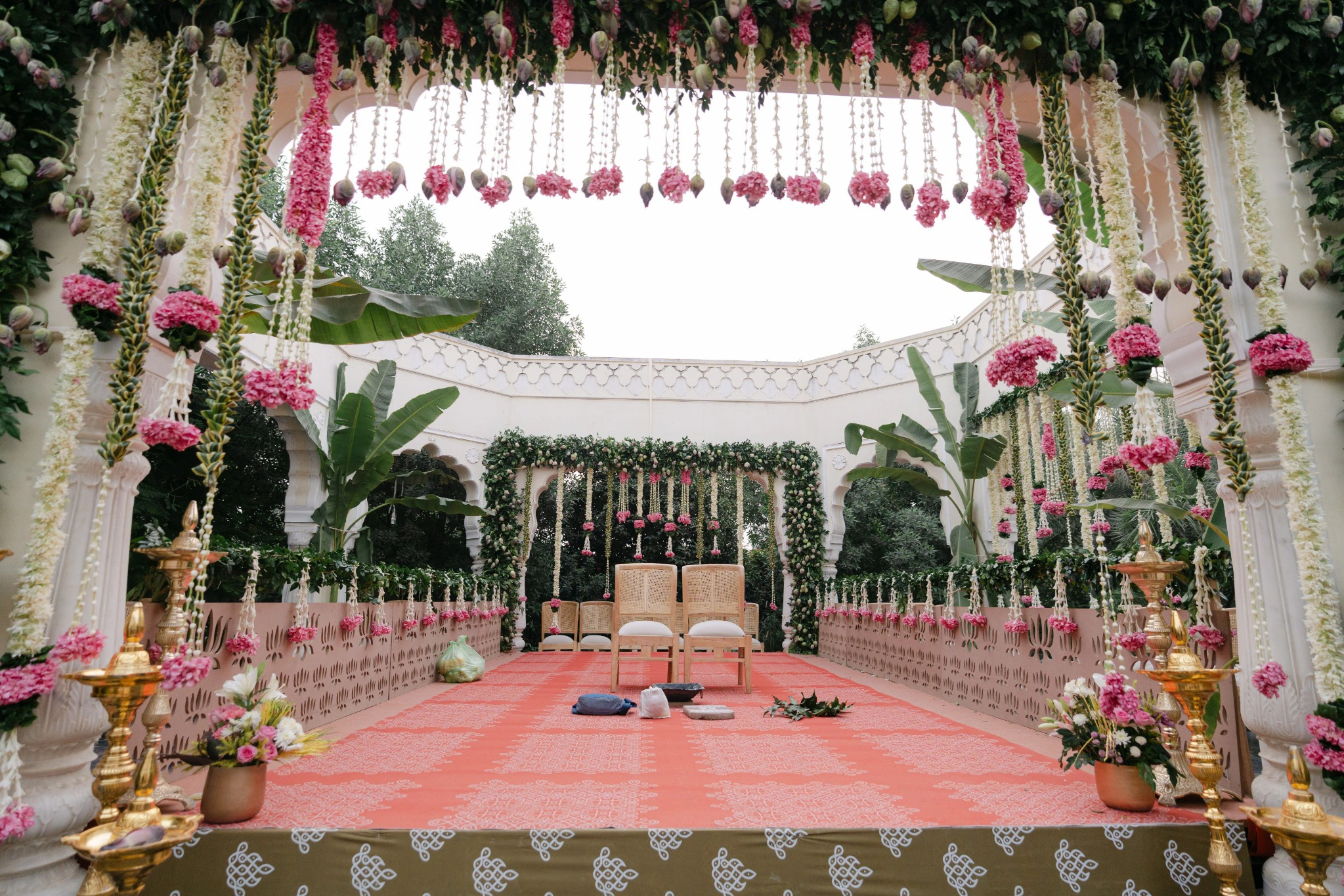 Lotus and white flower hangings inside the wedding mandap at Hyatt Regency Jaipur Mansarovar, Jaipur