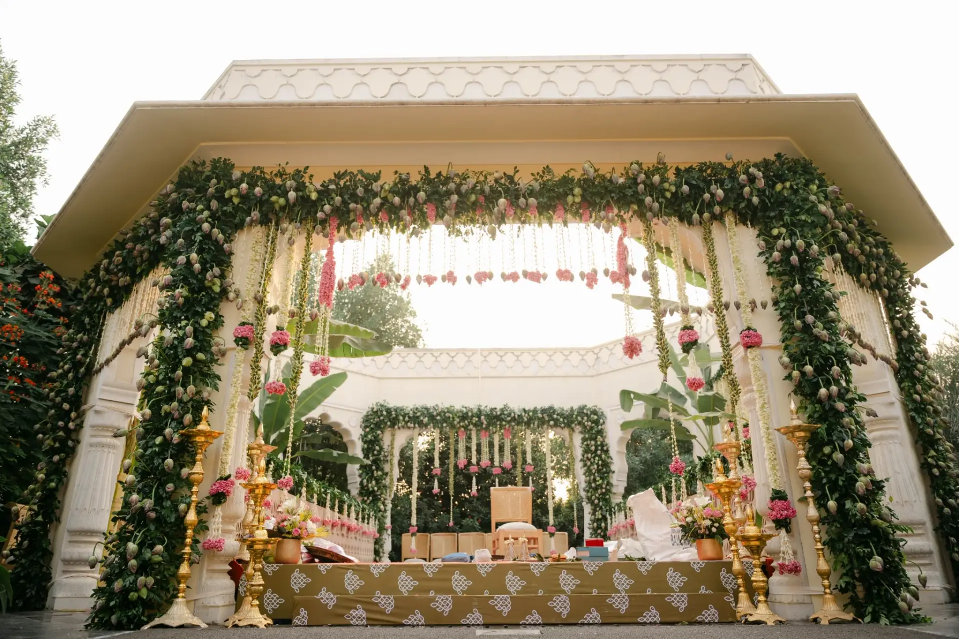 Wedding mandap framed by a floral arch at Hyatt Regency Jaipur Mansarovar, Jaipur