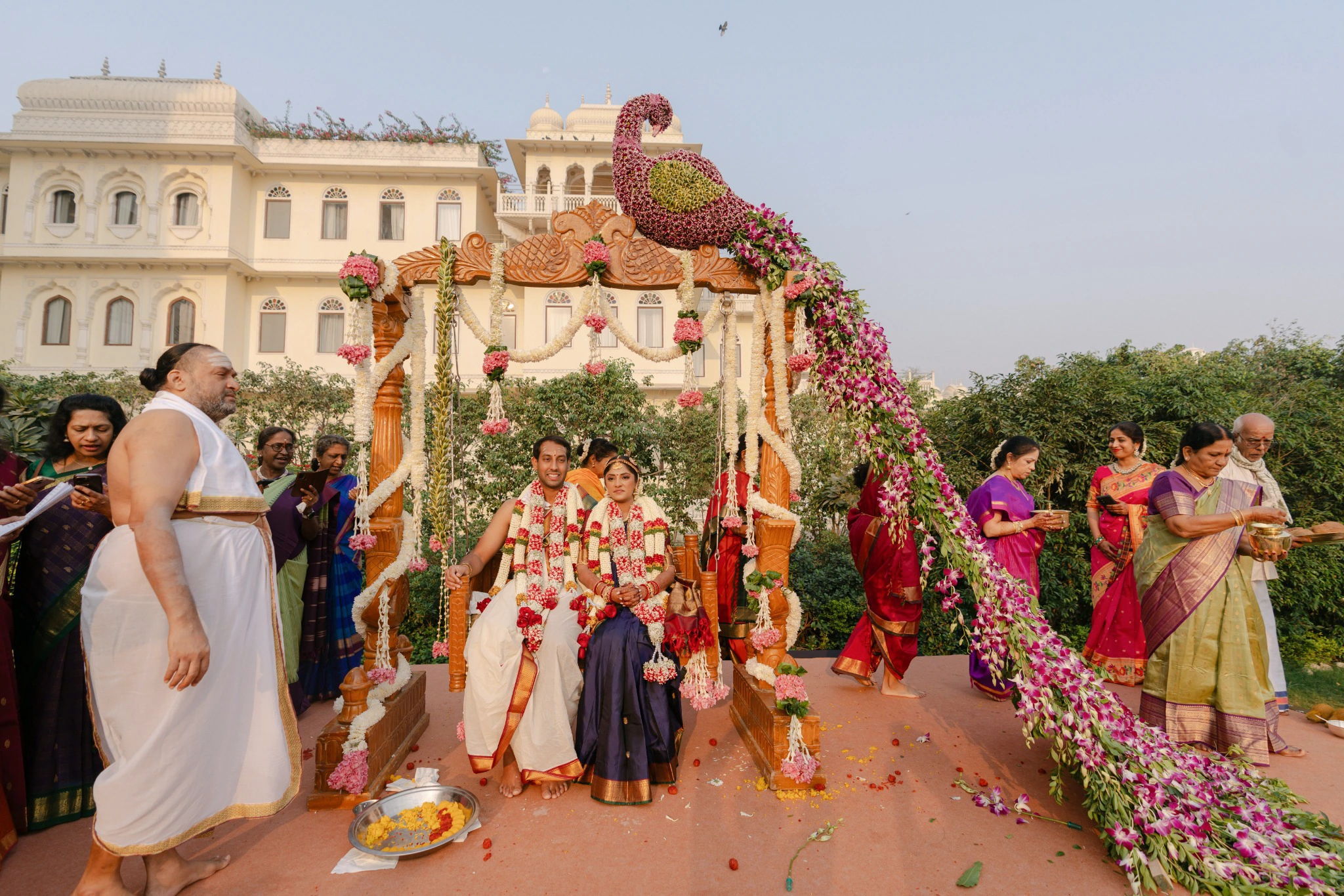 Ankita and Ajay on the wooden oonjal swing beneath a floral peacock at Hyatt Regency Jaipur Mansarovar, Jaipur