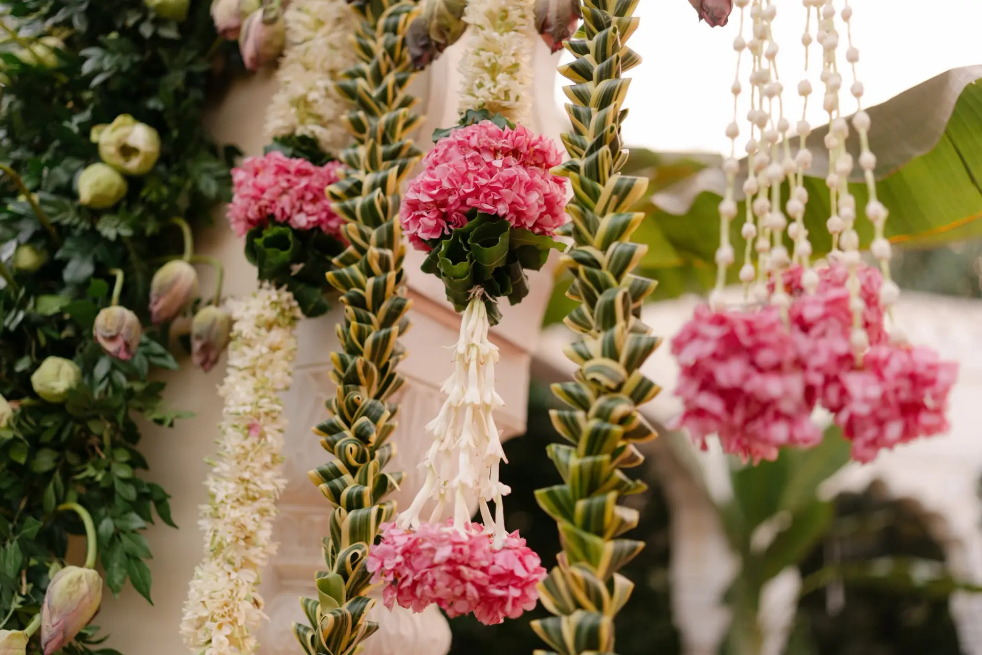 White flower strings with pink floral accents at Hyatt Regency Jaipur Mansarovar, Jaipur