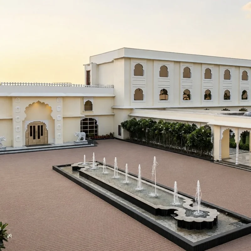 Palatial courtyard with arched façades and a linear fountain at Beelwa Palace.