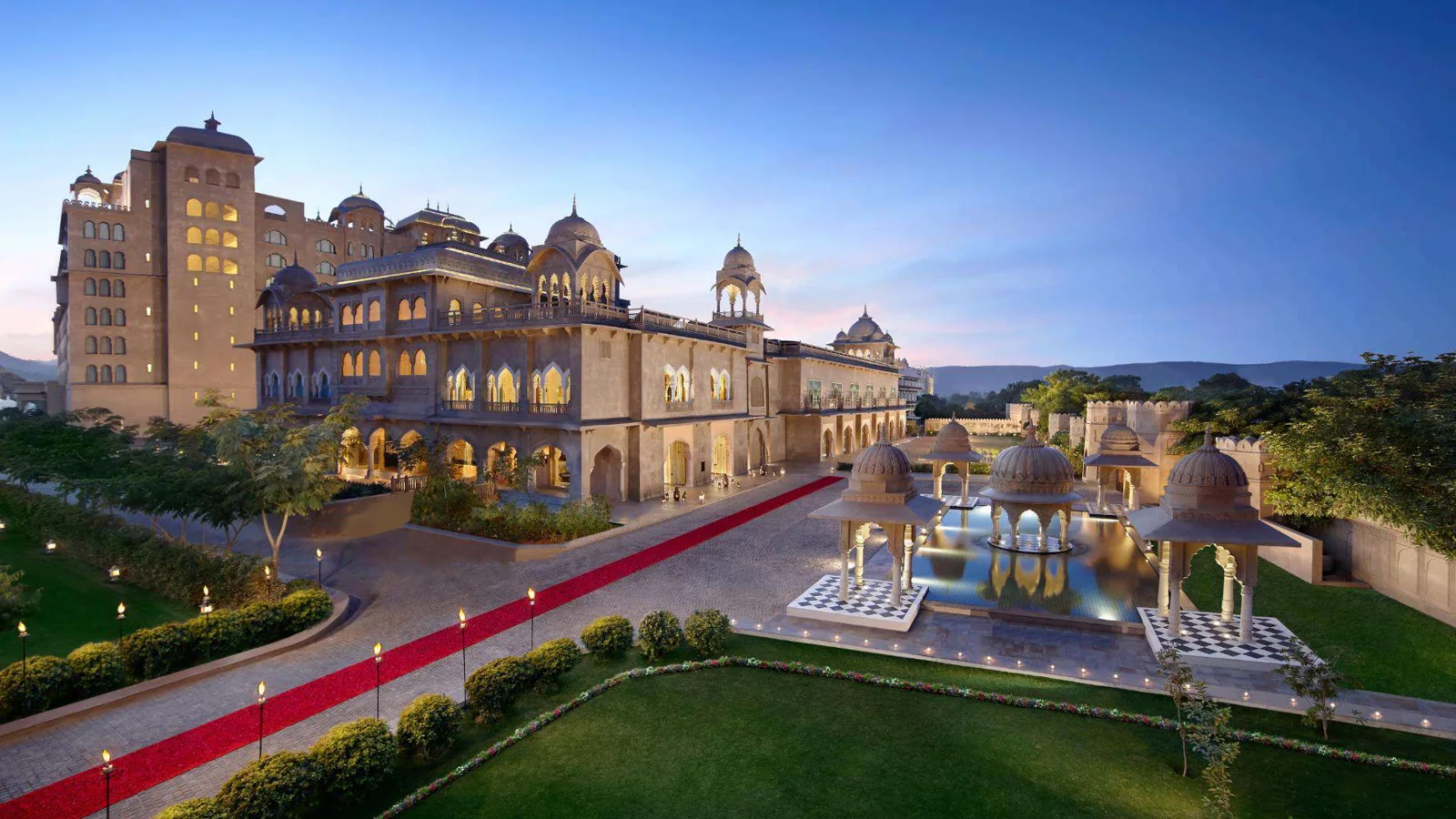 Fairmont Jaipur palace façade, gardens and reflecting pools with domed pavilions at dusk