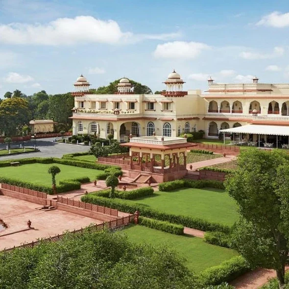 Palace façade overlooking formal Mughal-style gardens at Jai Mahal Palace.