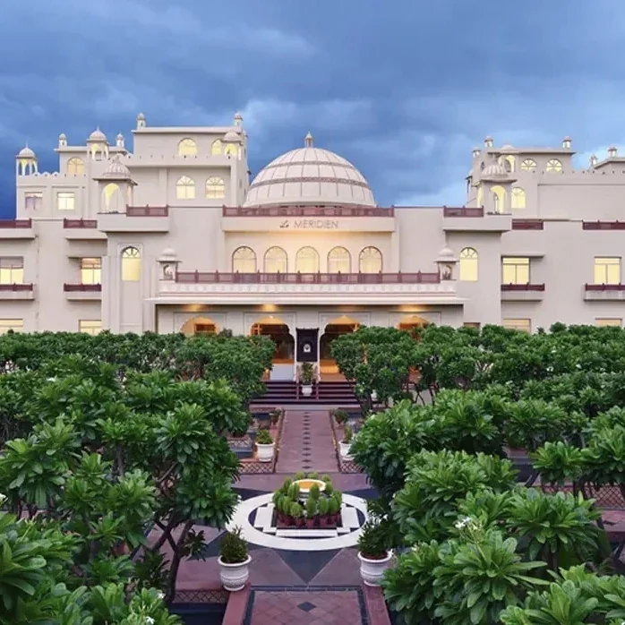 Palace-inspired façade and landscaped central approach at Le Méridien Jaipur Resort & Spa.