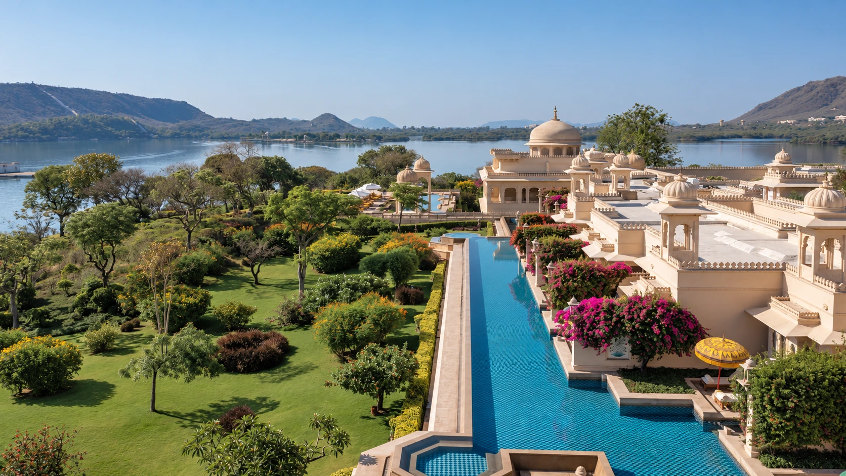 The Oberoi Udaivilas gardens, pool and palace overlooking Lake Pichola