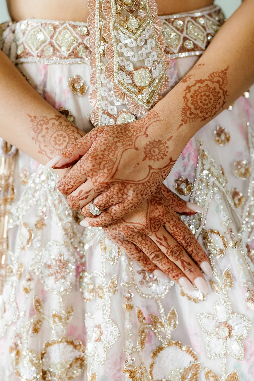 Mehndi on the bride’s hands with her wedding outfit