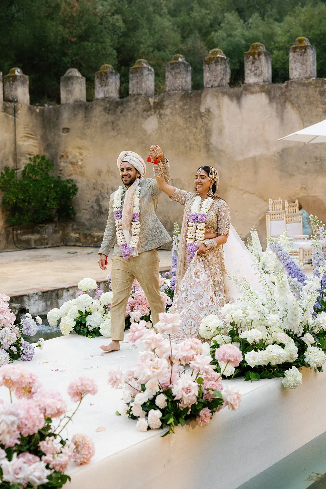 Bride and groom celebrating together during their courtyard wedding ceremony at Penha Longa