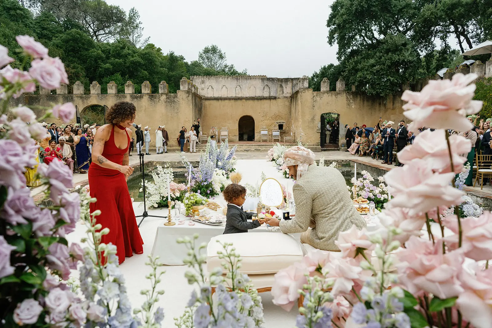 Family gathered around a wedding ceremony moment in the Penha Longa courtyard