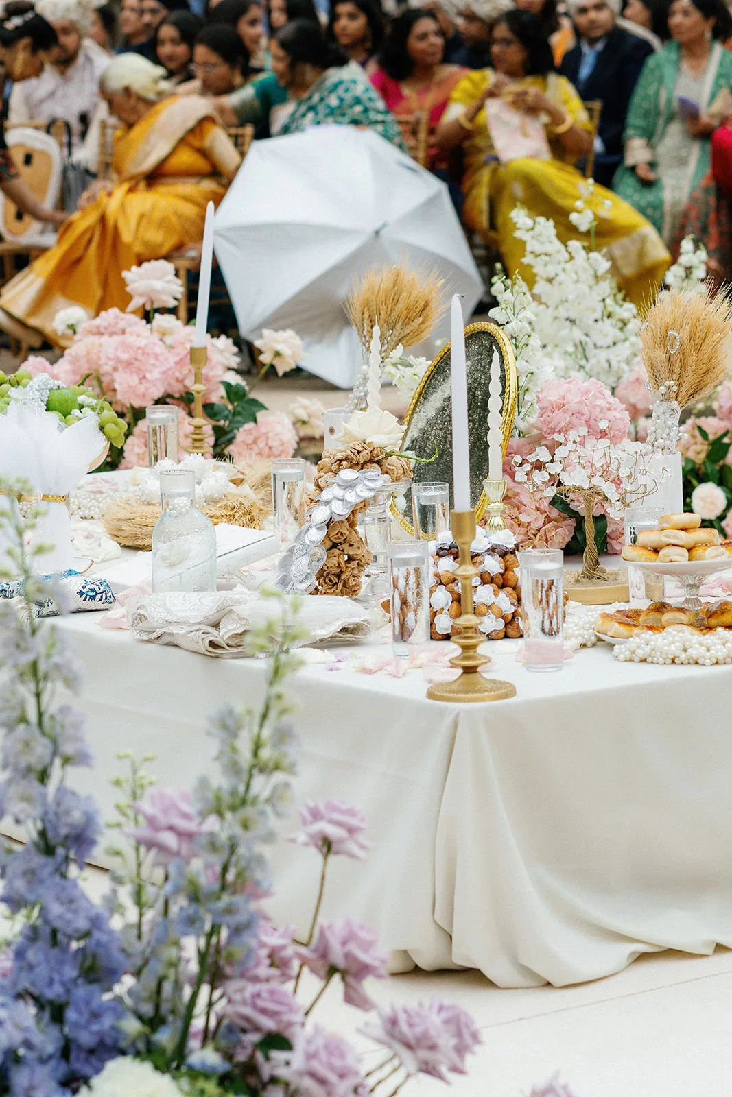Wedding-day food and sweets displayed among pastel flowers