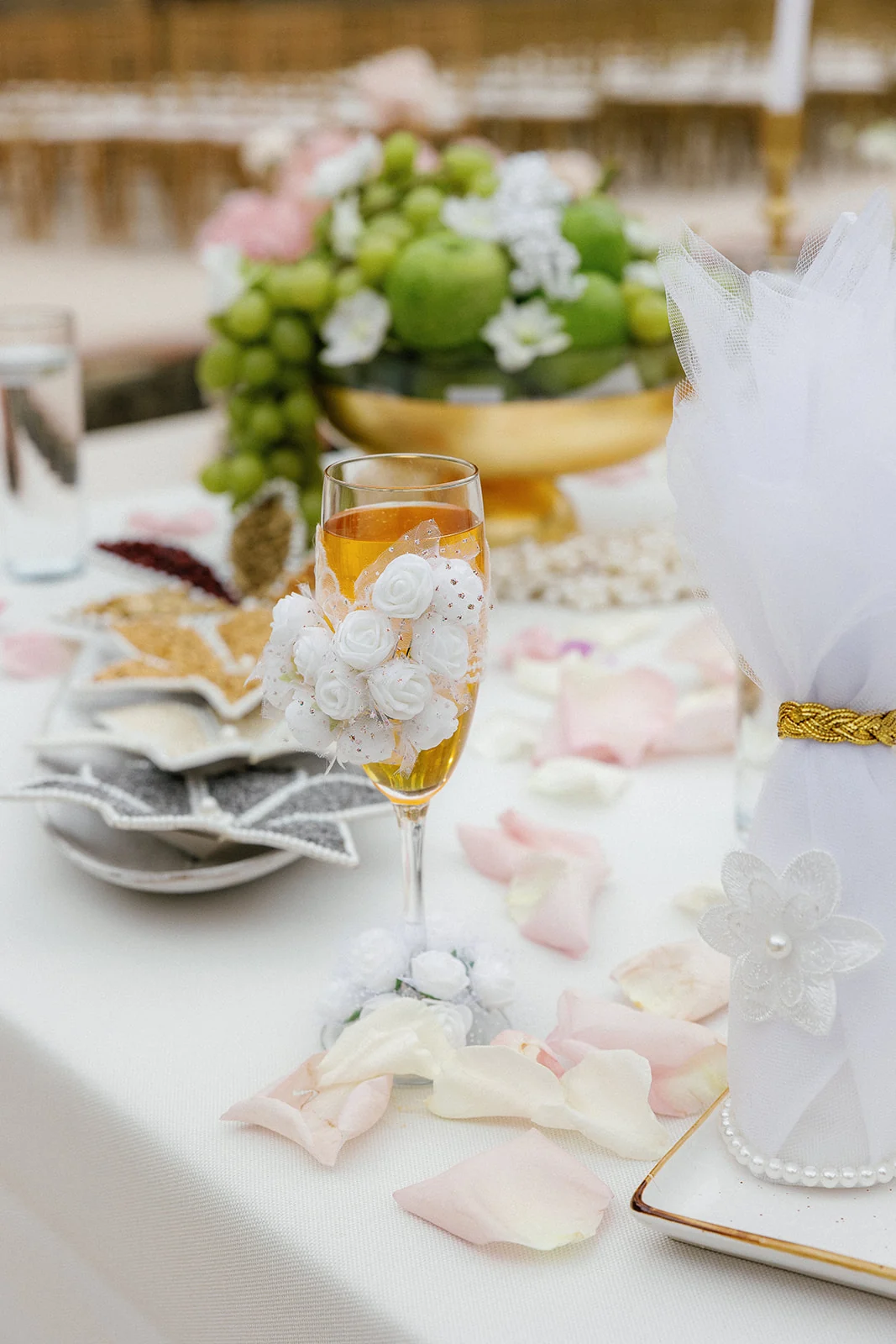 Wedding-day table details with flowers, gold-toned accents and food