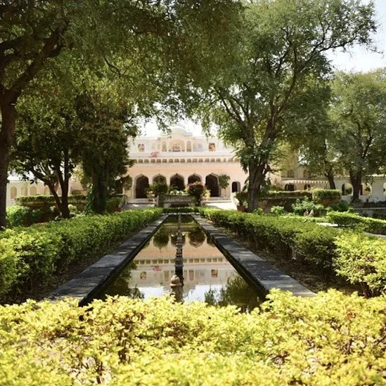 Formal garden avenue and central water channel leading to a heritage pavilion at Samode Bagh.