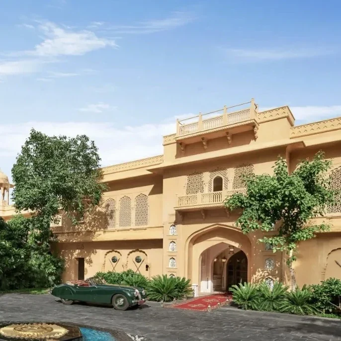 Sandstone-coloured entrance and landscaped approach at Sawai Man Mahal.
