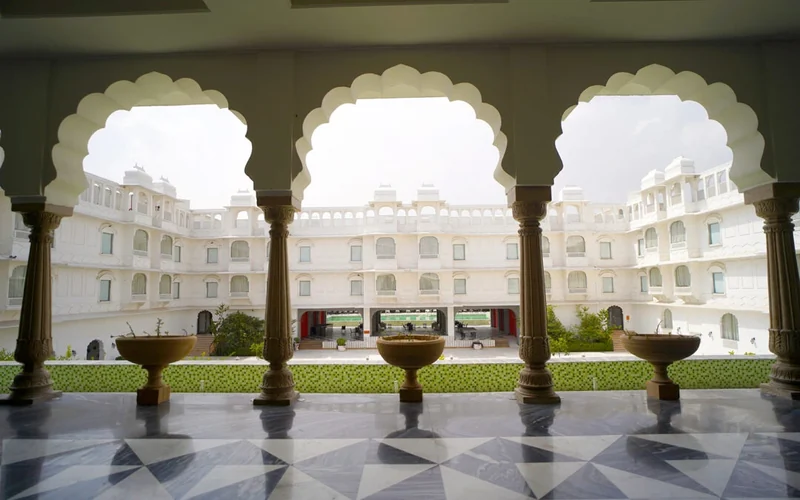 Scalloped arches framing the white courtyard at The Palace by Park Jewels.